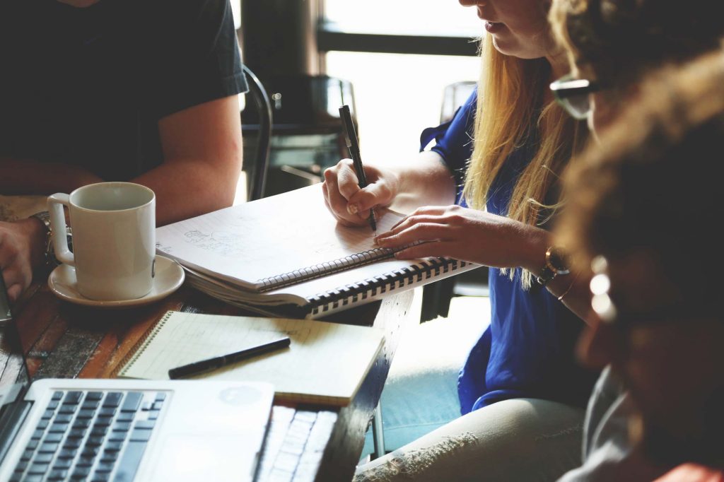 a group of people sitting at a table discussing IT Support for accounting firms